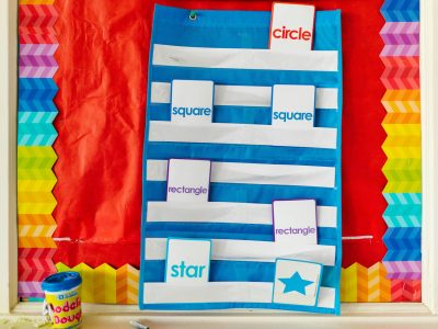 Bright classroom display featuring vibrant geometric shapes like circle, square, and star.